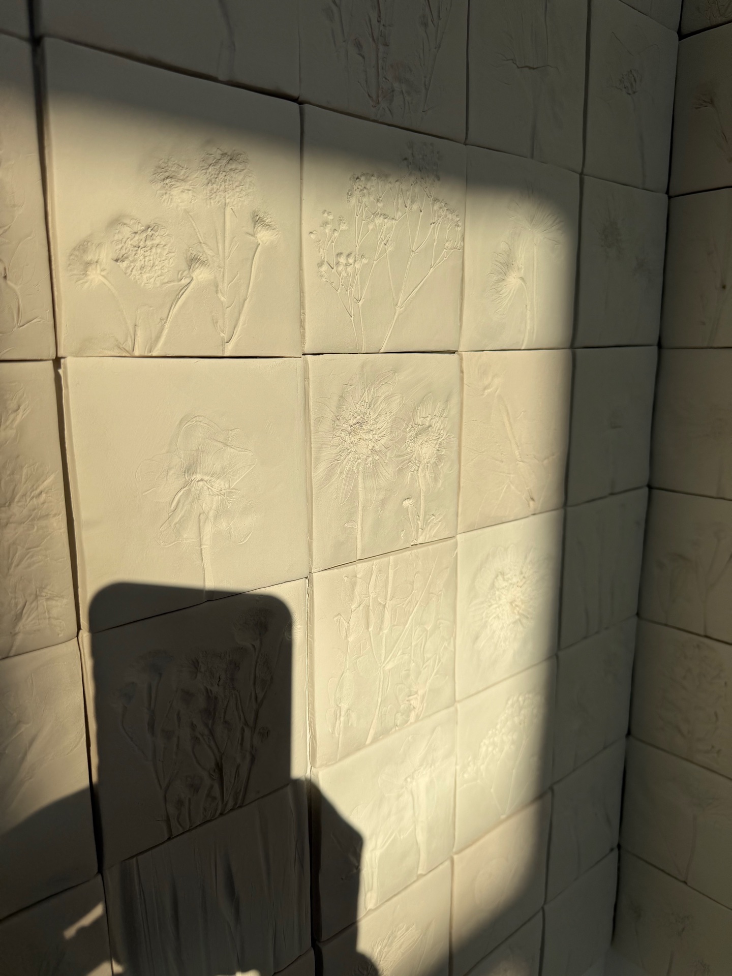 In Memoriam — ceramic tiles in raking light